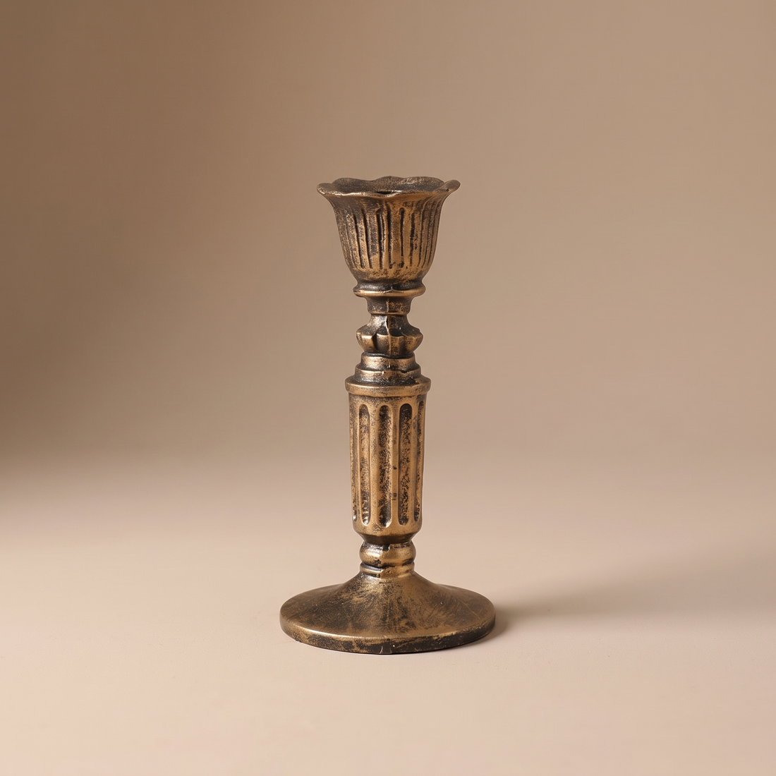 Vintage taper candle holder in antiqued bronze, styled as a mantel and dining-table centerpiece accent