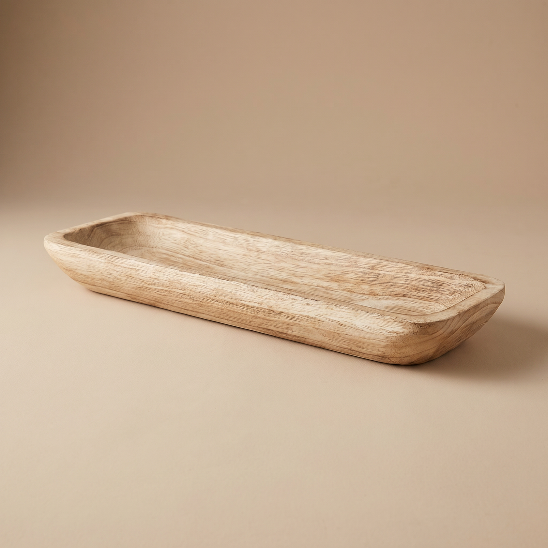 Hand-carved wooden dough bowl styled as a decorative centerpiece on an open shelf