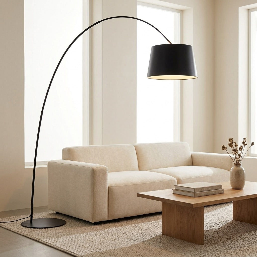 Nordic Minimalist Arc Floor Lamp with matte-black curved arm providing ambient light over a seating area