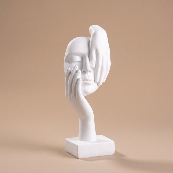 Abstract resin face statue styled on a minimalist console table