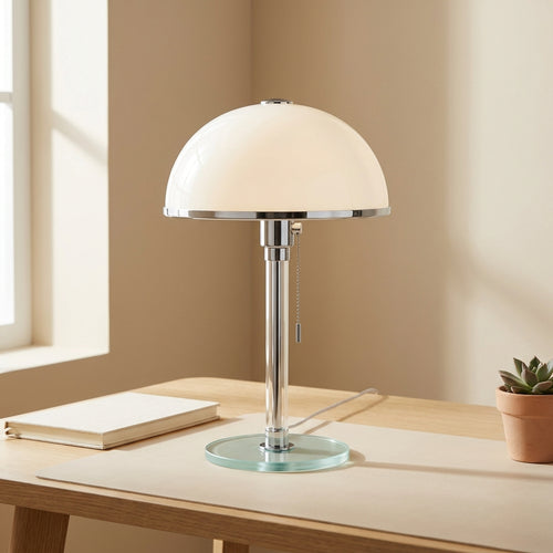 Bauhaus dome table lamp with milky-white opal-glass shade, chrome-and-glass stem, and tinted round glass base on a desk