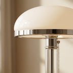 Bauhaus opal-glass dome table lamp styled on a nightstand for ambient lighting