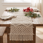 Cream bohemian macramé runner on a wood table with pomegranates and eucalyptus