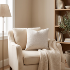 Camel bouclé cushion on a wooden bench in a minimalist entryway