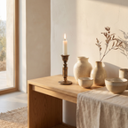 Bronze taper holder styled as a centerpiece with dried botanicals