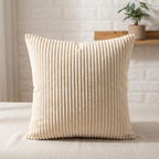 Light coffee corduroy lumbar cushion on a made bed