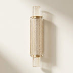 Slim column of stacked seeded champagne crystal-effect glass bars with gold-tone collars, glowing warm
