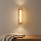 Warm refracted light scattering through bubbled glass bars of the column sconce