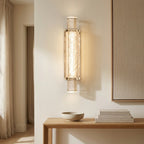 Pair of bubbled glass column wall sconces with gold-tone collars in a room setting