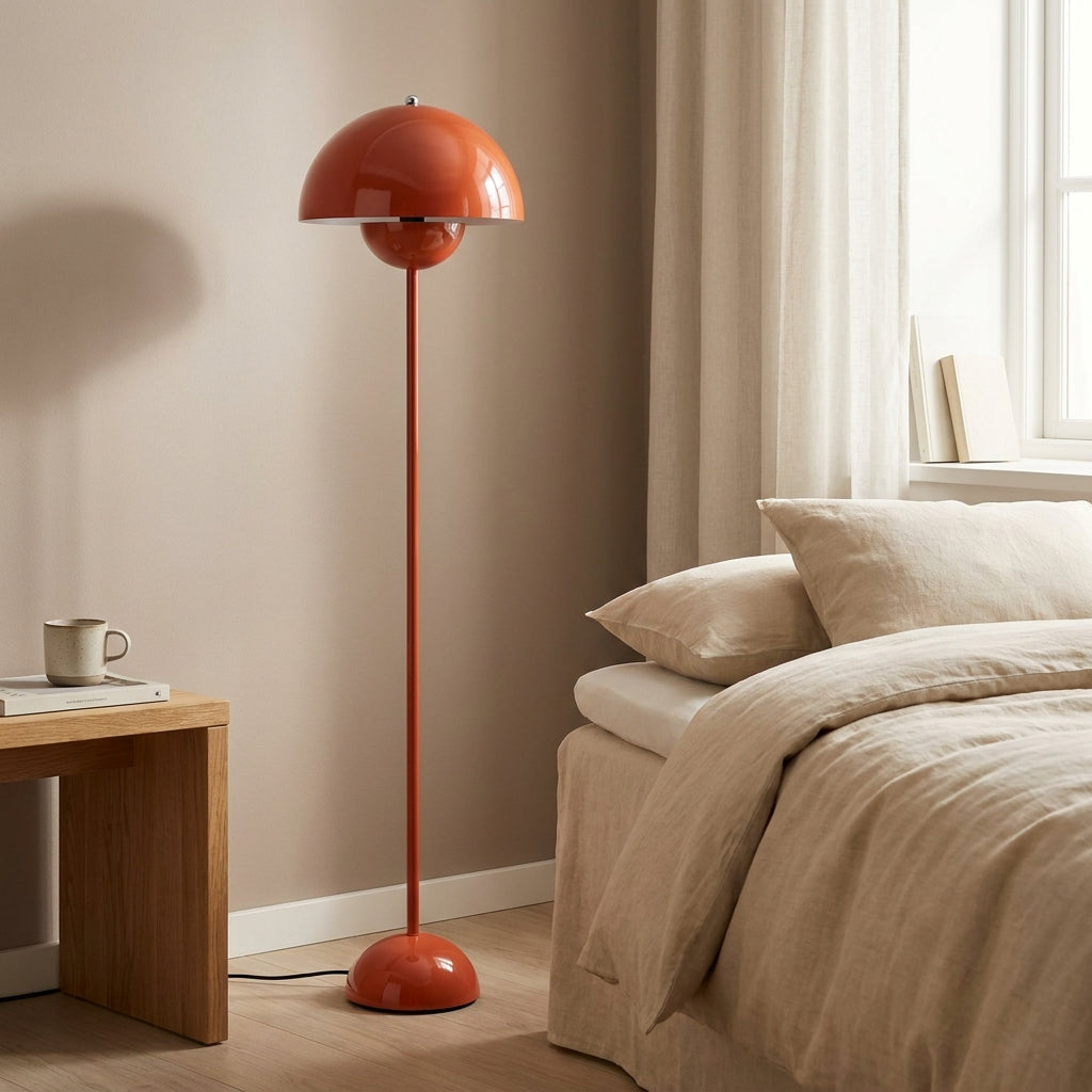 Glossy red-orange mushroom-dome floor lamp with a slim straight pole and rounded base
