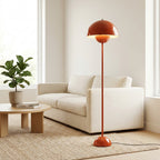 Close-up of the glossy red-orange domed mushroom shade glowing warm underneath