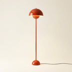 Glossy red-orange mushroom-dome floor lamp shown full length against a neutral wall