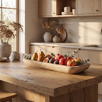 Elongated wooden dough bowl styled with clustered pillar candles on a coffee table