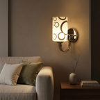 Chrome patterned-glass wall sconce on a living room accent wall beside a sofa