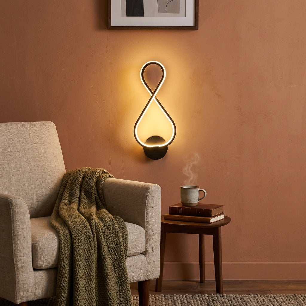 Nordic Figure-Eight LED Wall Sconce in black beside a reading chair