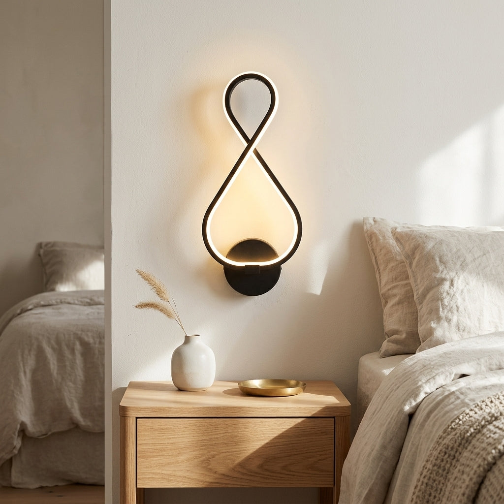 Nordic Figure-Eight LED Wall Sconce in black above a bedside nightstand