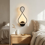 Nordic Figure-Eight LED Wall Sconce in black above a bedside nightstand