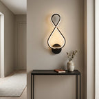 Nordic Figure-Eight LED Wall Sconce in black on a hallway wall