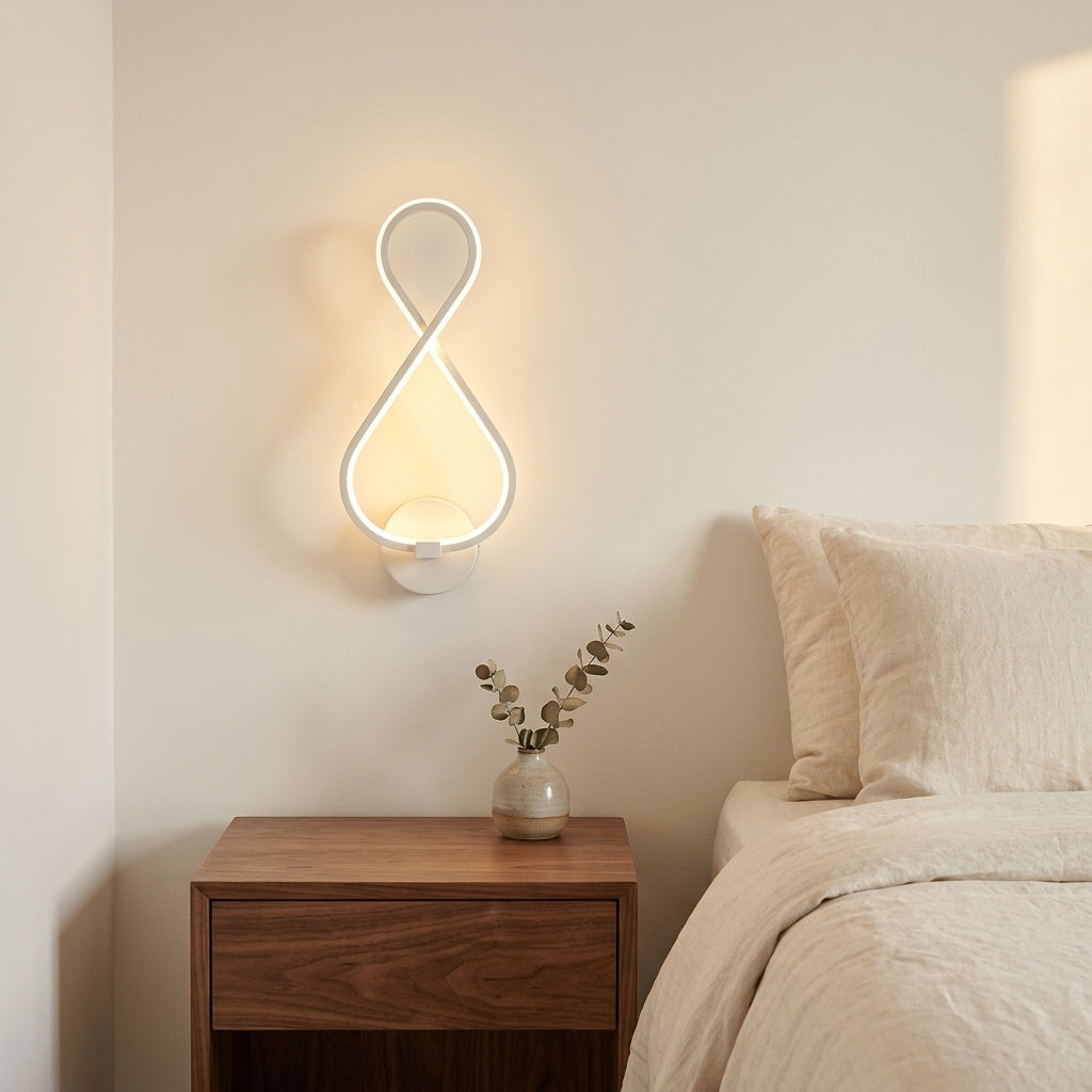 Nordic Figure-Eight LED Wall Sconce in white above a bedside nightstand