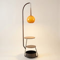 Arched wood and metal floor lamp with amber glass globe shade and two round wood shelves