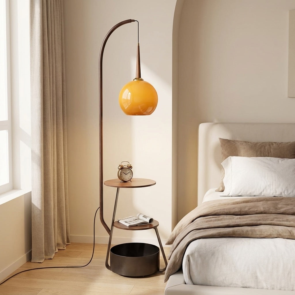 Full view of the arched floor lamp with wood shelves and amber glass globe