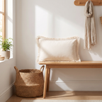 Ivory fringed lumbar cushion cover on an entryway bench