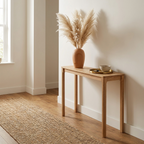 Camel mask vase with dried grass on a light-wood entryway console