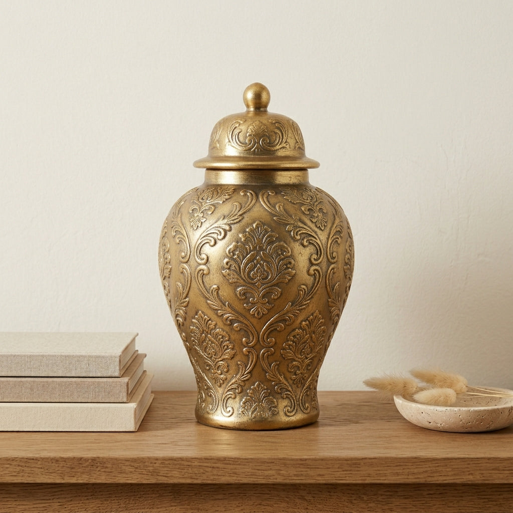 Full-body silhouette of the rounded gold-tone embossed ginger jar vase against a neutral background