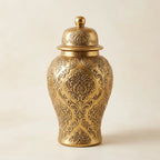 Antique-gold ginger jar styled on a dresser with stacked books in a calm corner