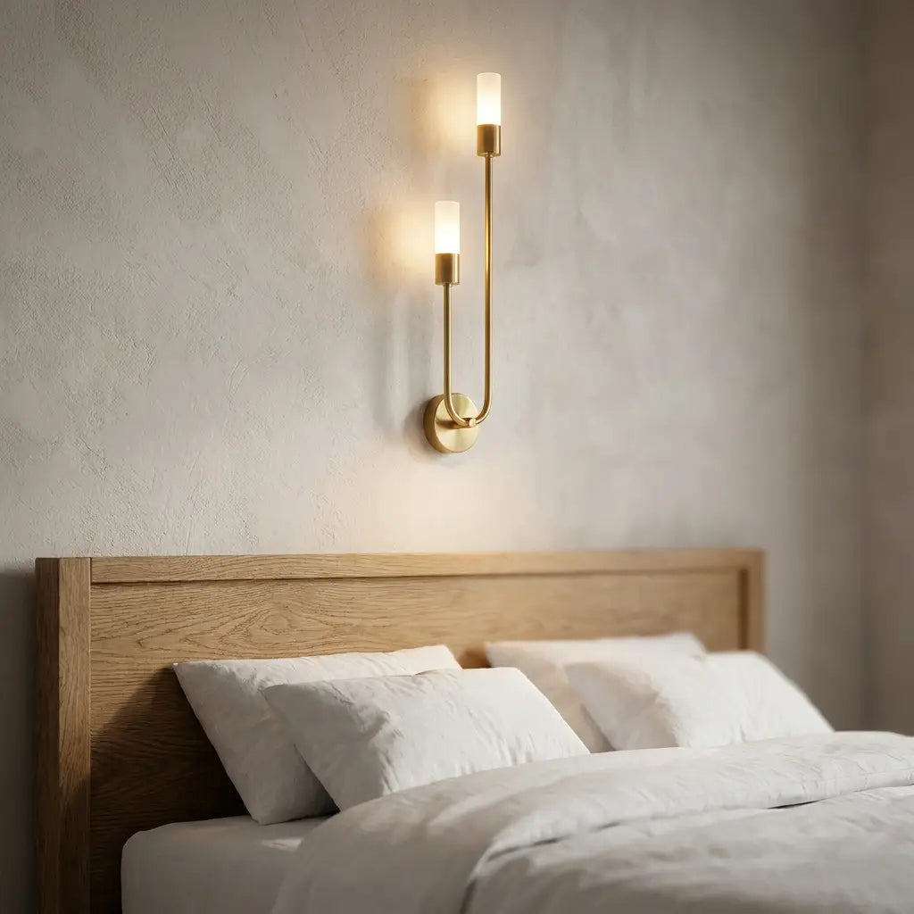 Nordic luxe black-and-gold wall sconce — above oak headboard with linen bedding