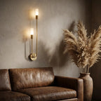 Nordic luxe black-and-gold wall sconce — above leather sofa as living-room accent