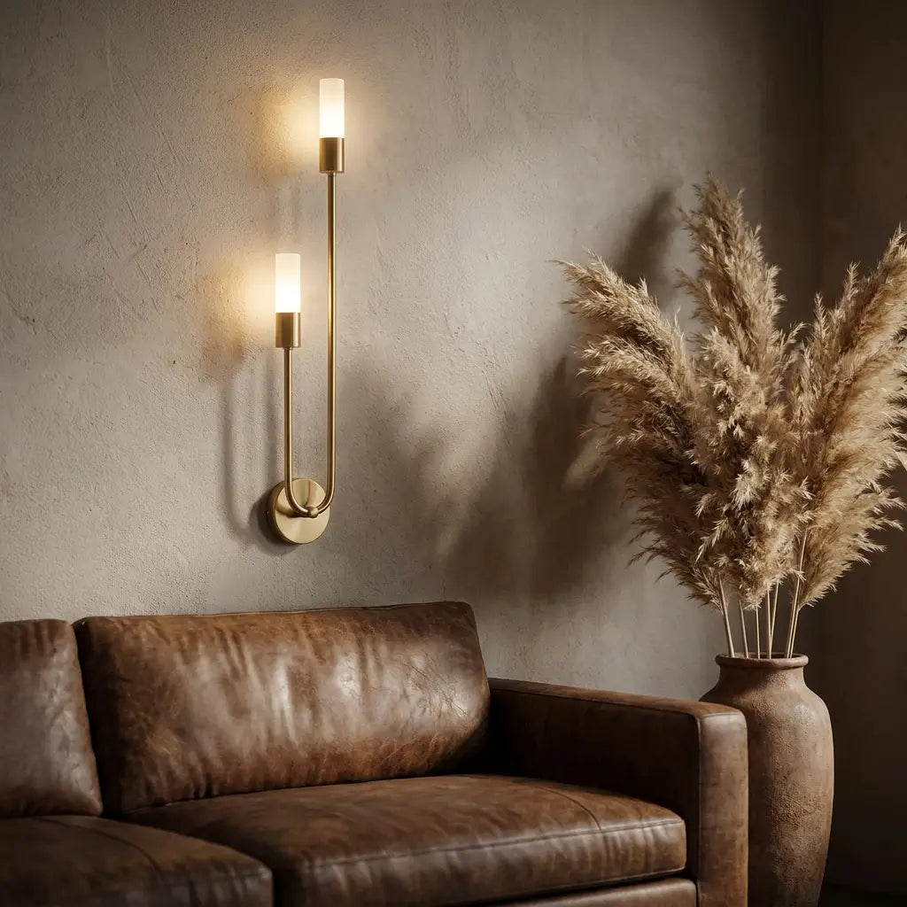 Nordic luxe black-and-gold wall sconce — above leather sofa as living-room accent