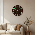 12-inch Nordic wood wall clock — on plaster gallery wall above linen sofa