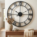 3D Roman numeral metal wall clock — in modern entryway above console table