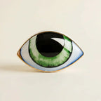 Nordic ceramic abstract evil-eye ornament sculpture — on warm cream studio backdrop