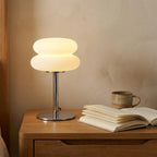 Cream-style bedside table lamp — on solid oak nightstand