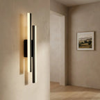 Copper-line LED wall sconce — above travertine bathroom vanity