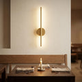 Cordless USB wall sconce — above dining bench in warm ambience