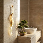 Long strip LED wall sconce — above travertine bathroom vanity