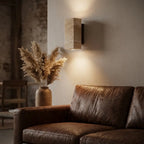 Wabi-Sabi travertine wall lamp — above leather sofa as living-room accent