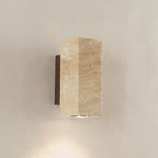 Wabi-Sabi travertine wall lamp — on textured plaster wall product shot