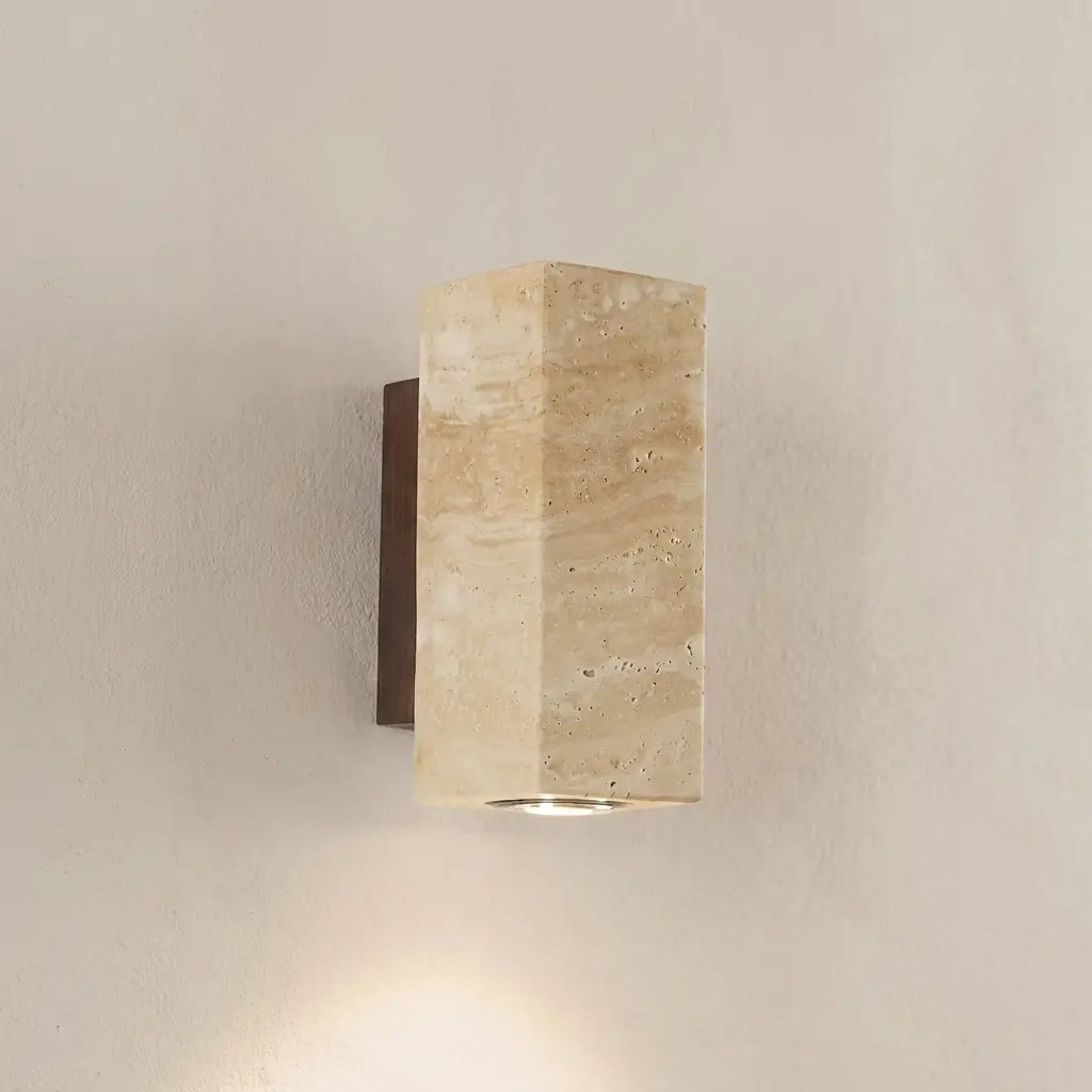 Wabi-Sabi travertine wall lamp — on textured plaster wall product shot