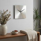 Stainless steel wall clock — in modern entryway above console table