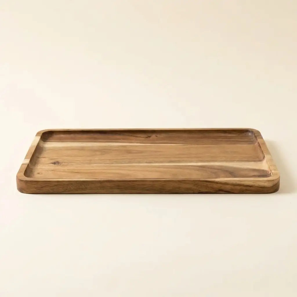 Natural acacia wood rectangular tray — on warm cream studio backdrop