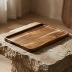 Natural acacia wood rectangular tray — dramatic low-angle hero shot