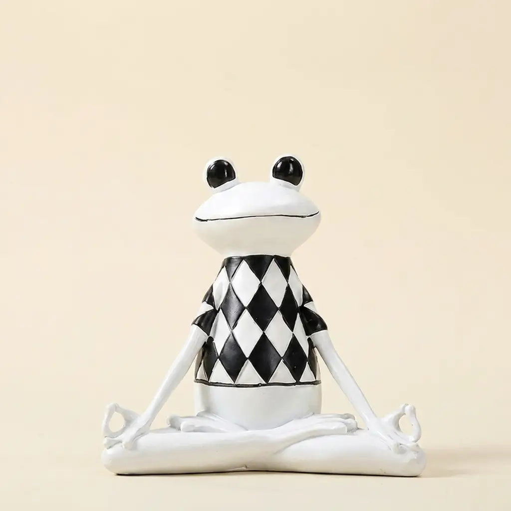 Yoga frog figurine — on warm cream studio backdrop