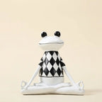 Yoga frog figurine — on warm cream studio backdrop