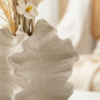 Geometric petal porcelain vase — on travertine coffee table