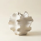 Geometric petal porcelain vase — on warm cream studio backdrop