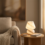 Moon-design glass mushroom lamp glowing beside a reading armchair